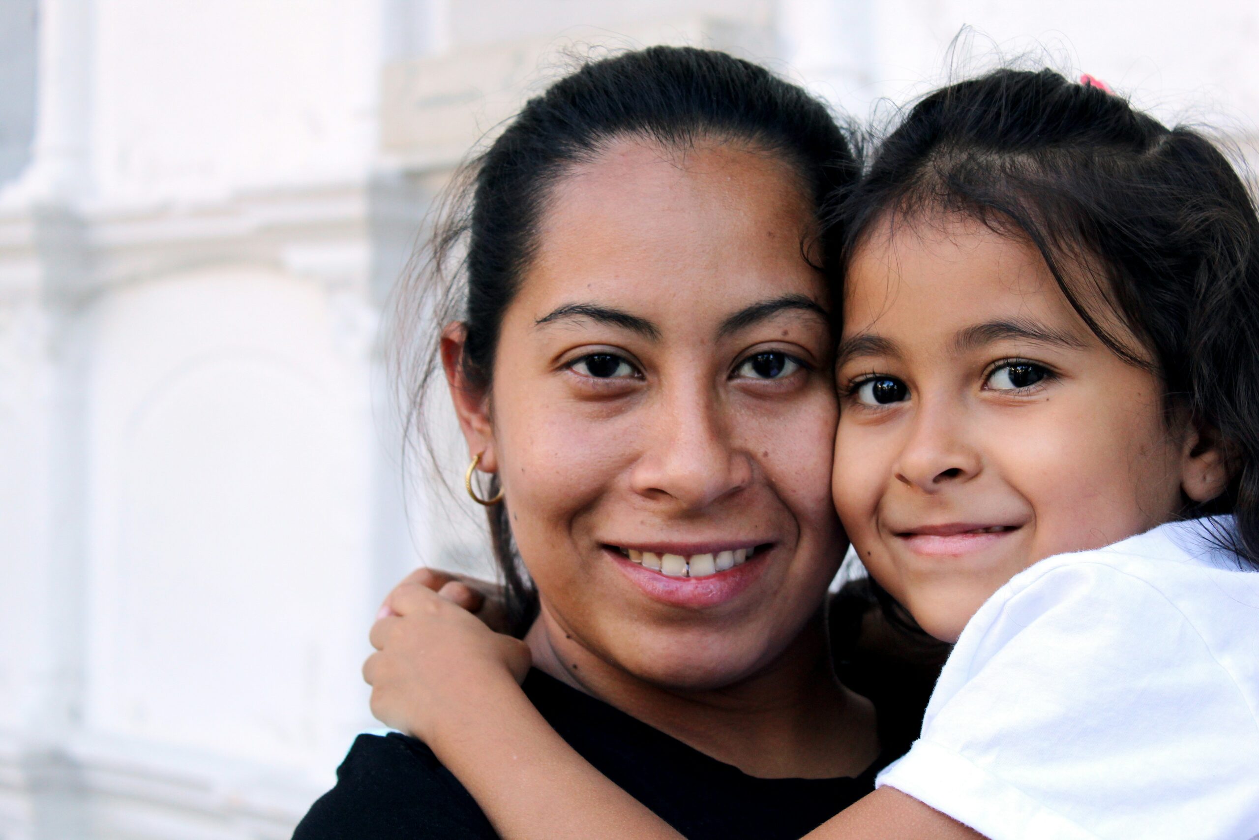 A woman and her daughter smile for the camera