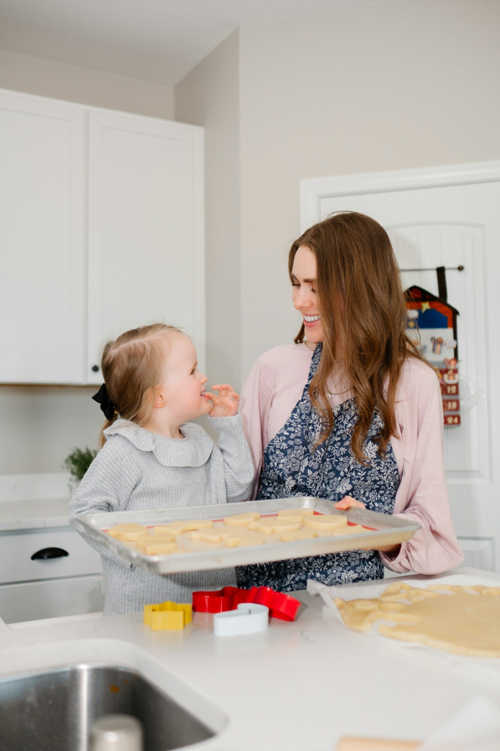 A woman and her young daughter in the kitchen