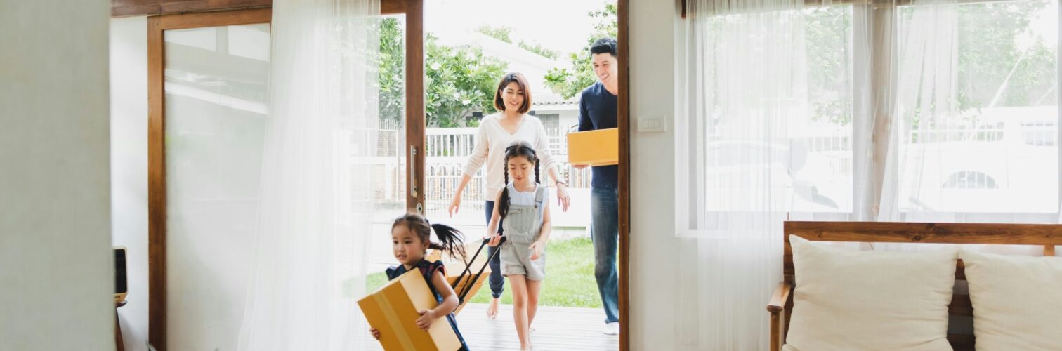 A family excitedly moves boxes into their new home